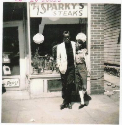 Two 15th ward residents pose outside a storefront.