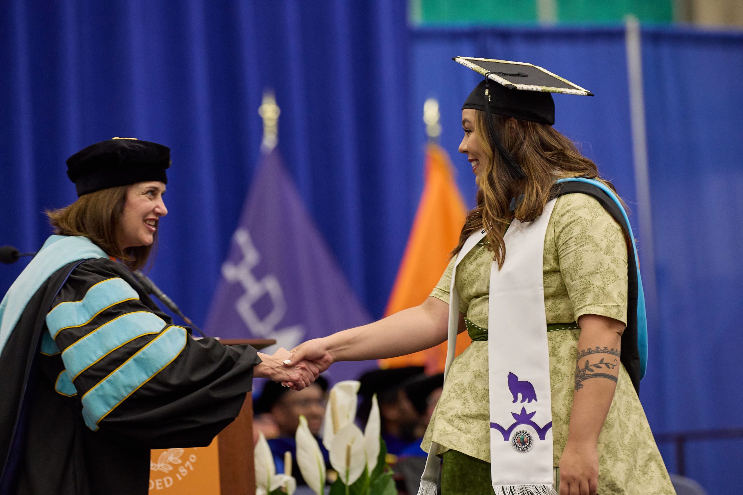 dean shakes graduate hand at convocation