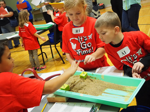 Students participating in lesson study with sand and water