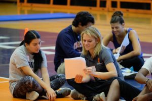 Health and Exercise Science students review placement materials in a gymnasium