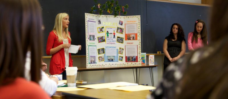 Student presents a posterboard in their class