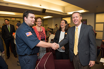 InclusiveU student Matt Sardino, left, School of Education Dean Joanna Masingila and Taishoff Center Executive Director Beth Myers greet State Sen. David Valesky at a  Peer-2-Peer pizza party hosted recently on campus.