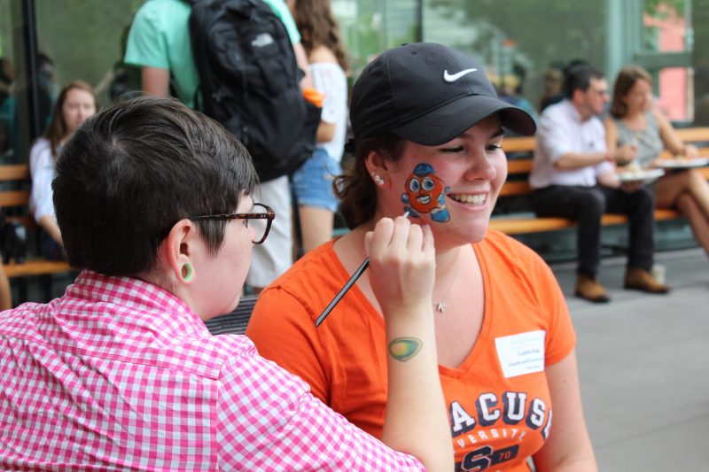 Student getting a picture of Otto the Orange painted on her cheek at the 2018 Welcome Back Picnic