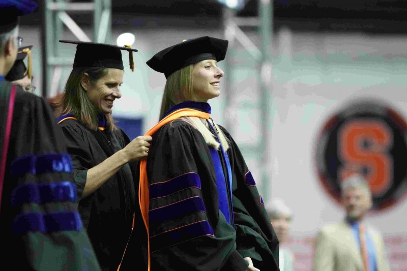 Doctoral student being hooded at graduation