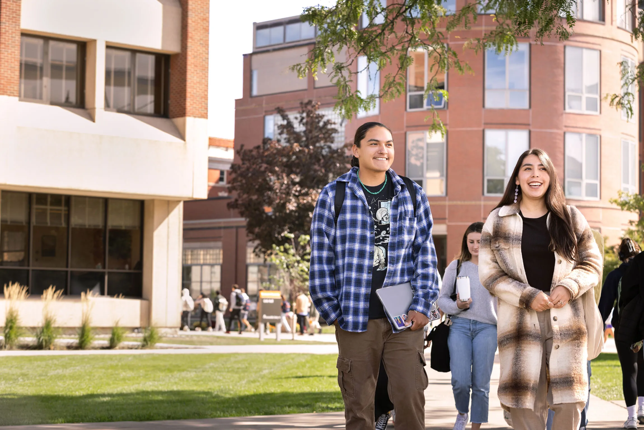 two indigenous students walking across campus near sims hall.