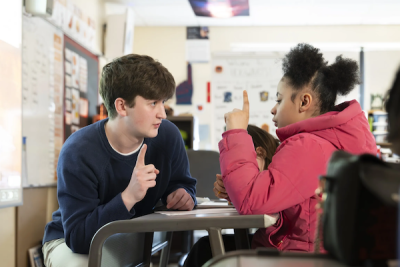 A student teacher and works with a young student