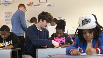 A student teacher sits down with a young student