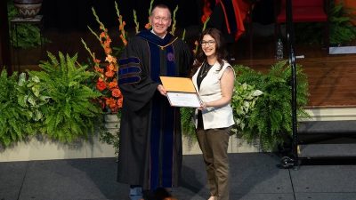 Aaliyah Muolo Vergara receives an award from Chancellor Mike Haynie