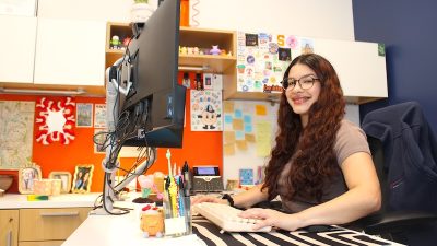 Aaliyah Muolo Vergara sits at her desk