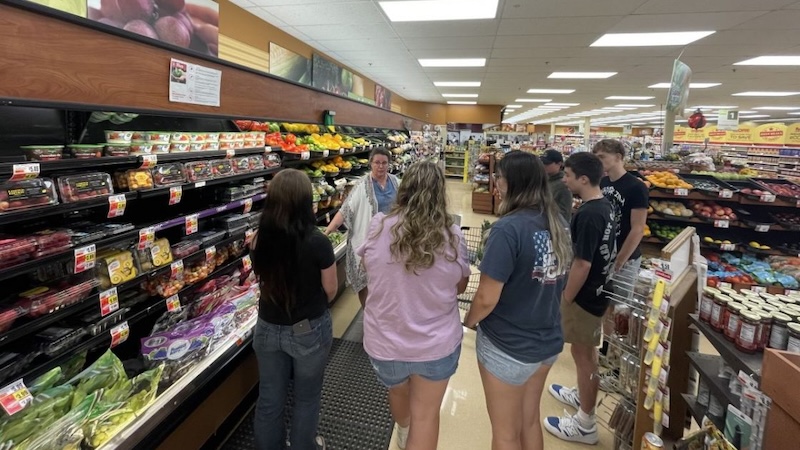 A group of teans in a laundromat