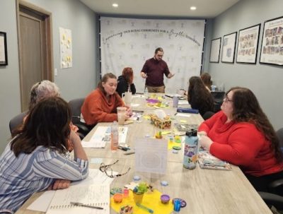 A group meets around a busy table