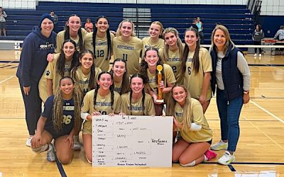 A volleyball team poses for a photo