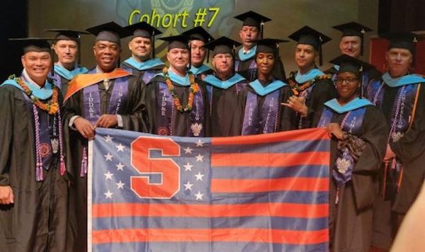 The IDDE military cohort of 2022 stand with an SU flag