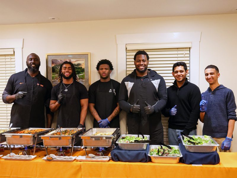 A group of students serve food at an event