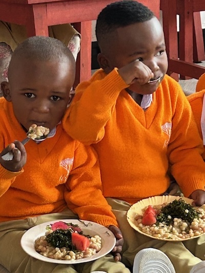 Two boys enjoy their lunch