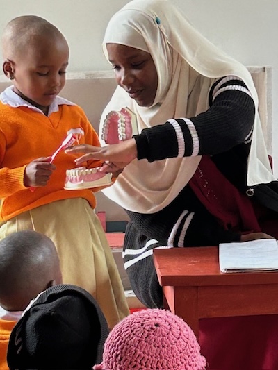 A little girl learns how to brush her teeth