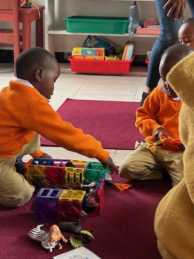 Two young students play with blocks