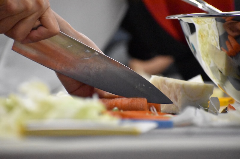 A closeup of carrots being chopped