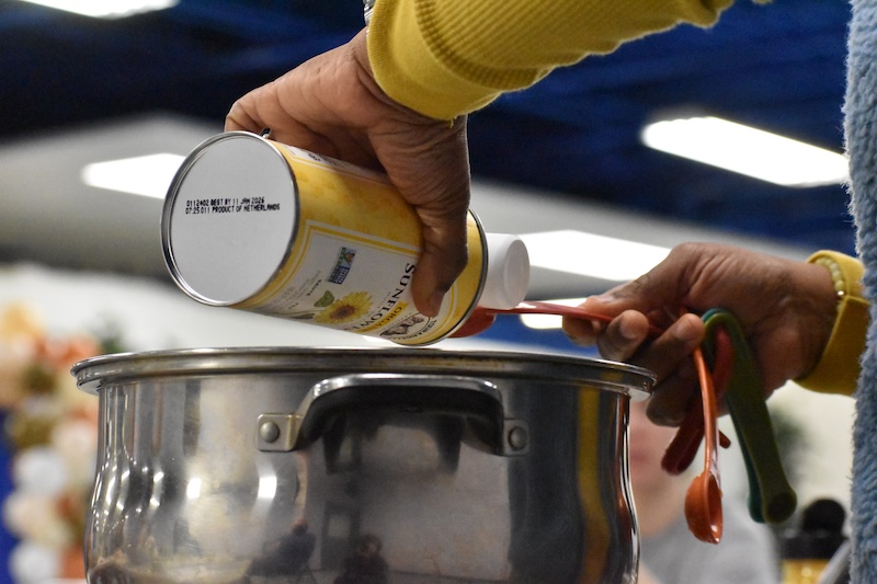 Turmeric being added to a pot