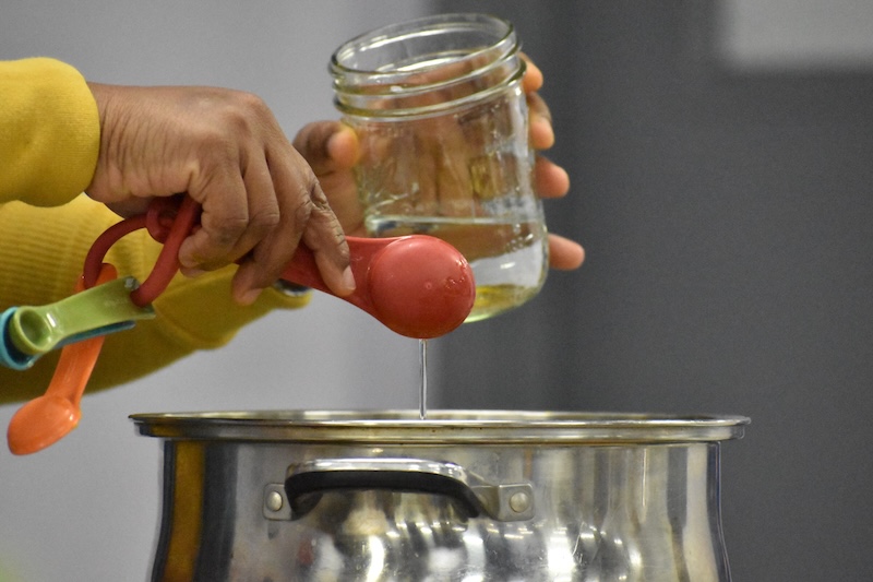 Close up of vinegar being poured in a pot