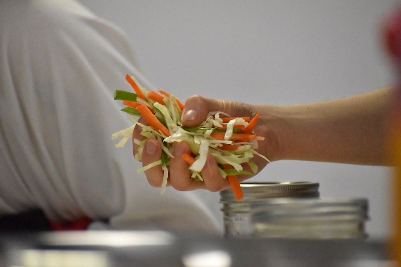 Chopped vegetables being put into a pot