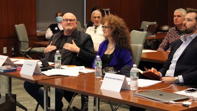 Intelligence++ judges seated at a table