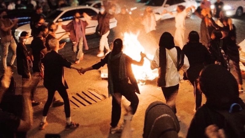 Women protestors dancing around a bonfire in Bandar Abbas