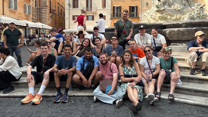 Students sitting outside the Parthenon in Italy