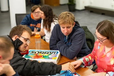 Students play board games around a large table