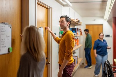 A man knocks on a classroom door