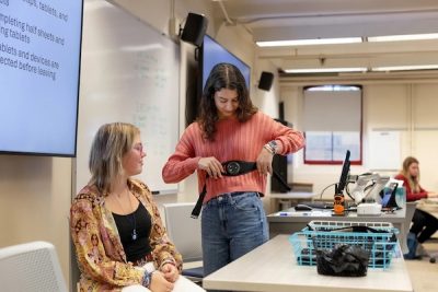 Two students test out physiology equipment