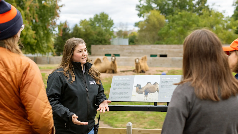 Mary Hillebrand stands in front of the camel exhibit