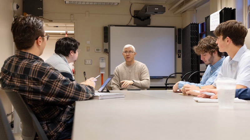 Professor Benjamin Dotger debriefs with students after a clinical simulation