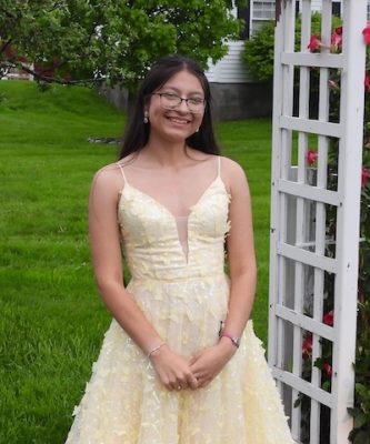 An Indigenous education student poses in a dress