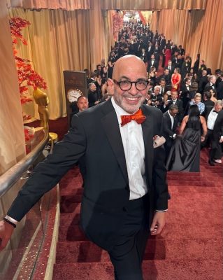 Jeff Goldstein stands on a red carpet at the Oscars