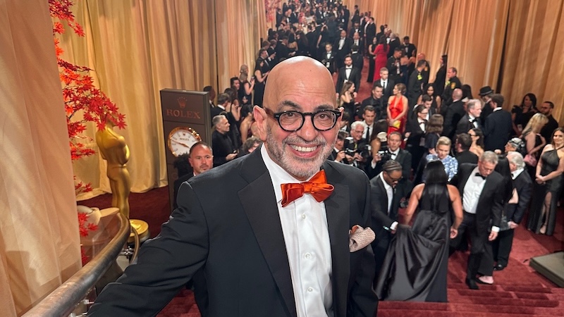 Jeff Goldstein stands on a red carpet at the Oscars