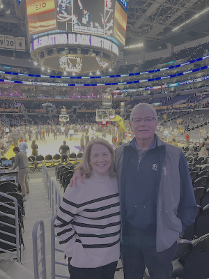 A husband and wife photographed at a basketball game