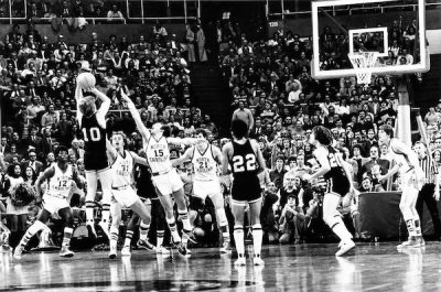 A black and white photo of a basketball jump shot