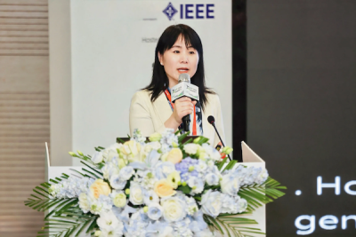 A professor speaks into a microphone