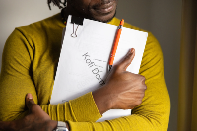 A man holds a screenplay close to his chest