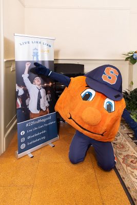 Otto the ORange next to a Live Like Liam sign
