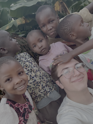 A student teacher takes a selfie with village children from Kenya