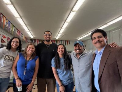 High school alumni pose together for a photo