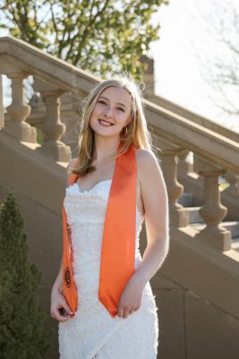 A female student wearing a graduation ribbon