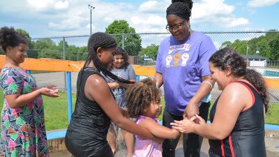 Moshiena Faircloth greets primary school students