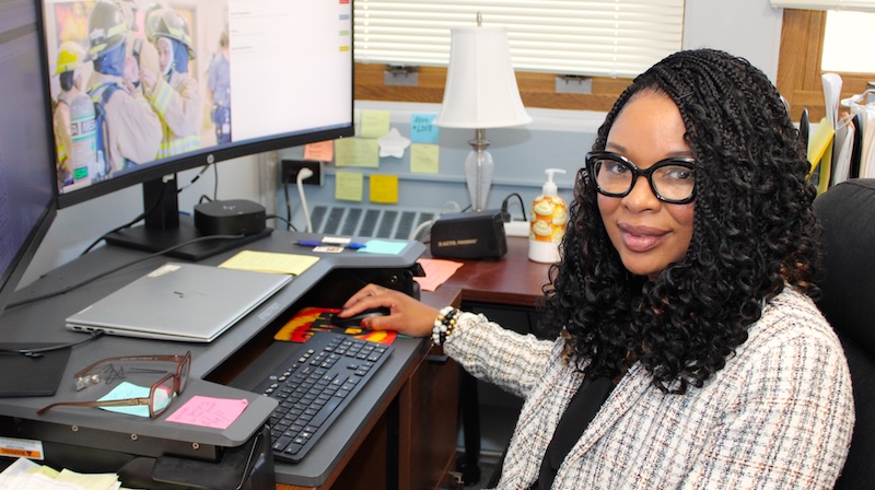 Pamela Odom sits at her desk