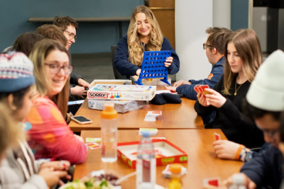 A group of students play card games together
