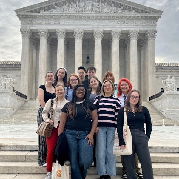 A group of students pose outside the US Supreme Court building.