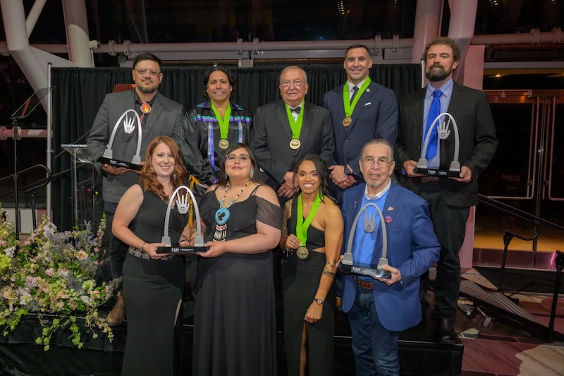 A group of American Indian athletes pose for a photo