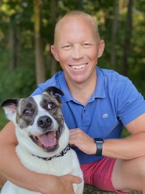 Rob Buyea poses with his dog